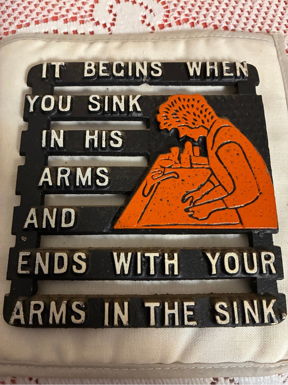 Black cast iron trivet humorous